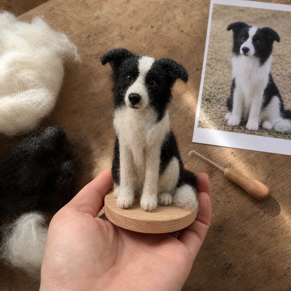 Handmade miniature border collie needle-felt pet sculpture held by an artisan